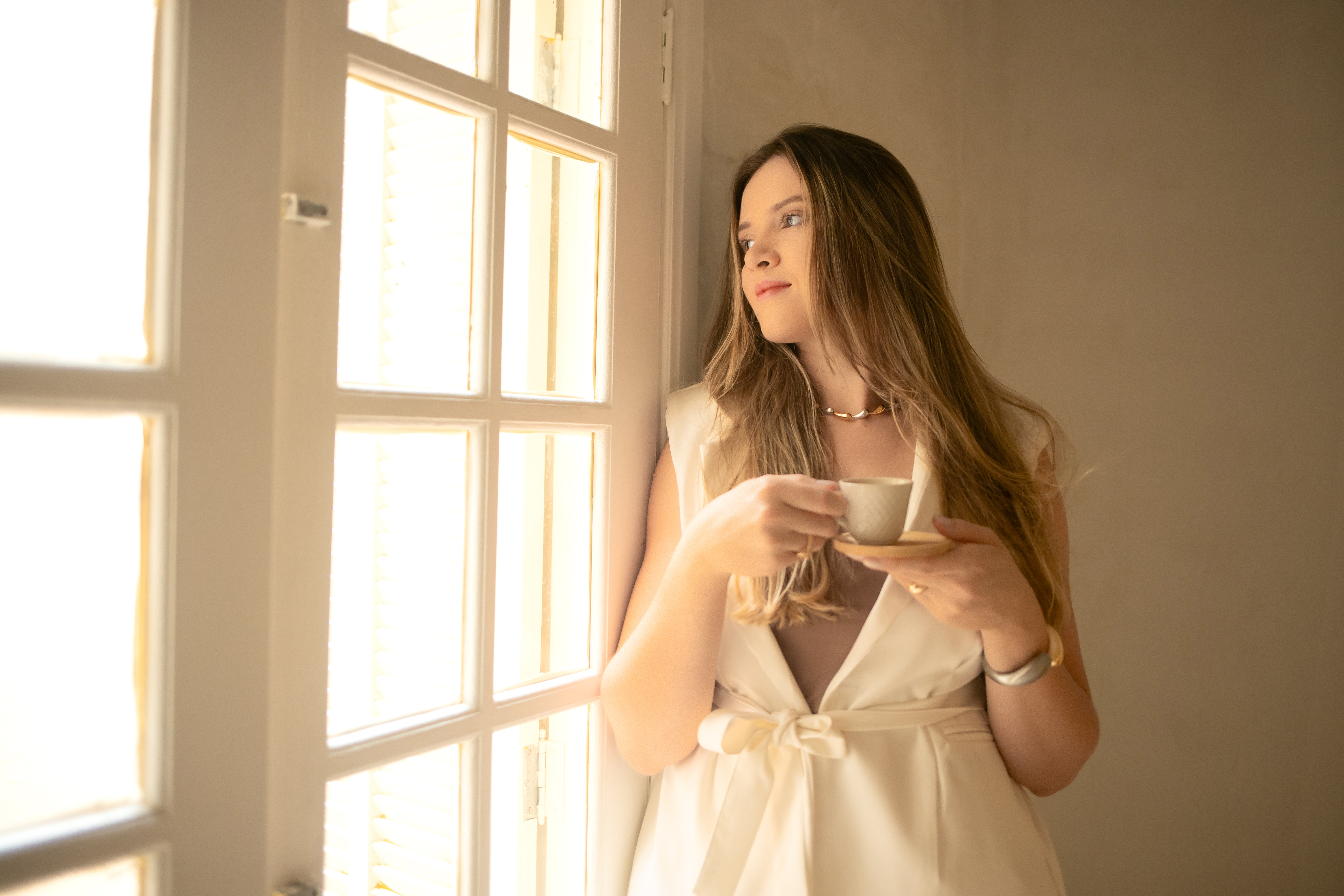 Akemilly Teixeira Lima sorrindo com uma xícara de café